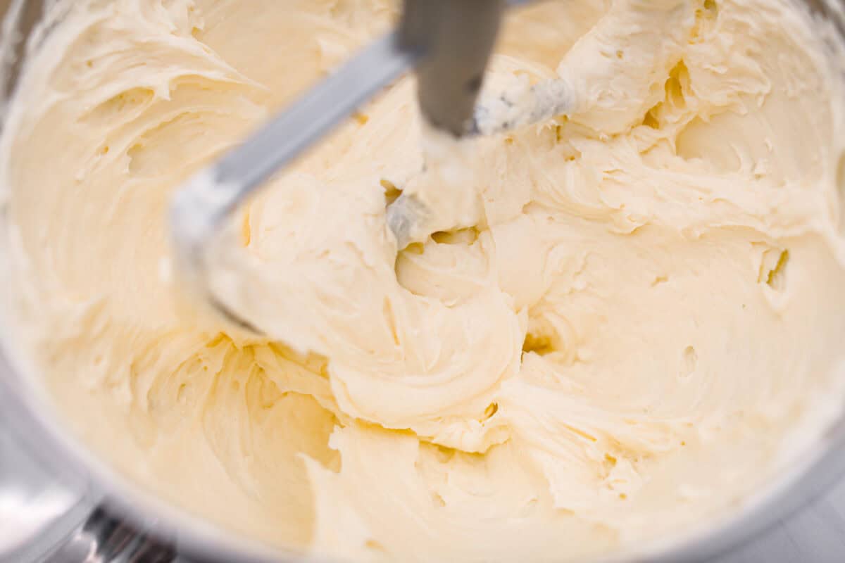 Fourth photo of the cream cheese beating in a stand mixer.