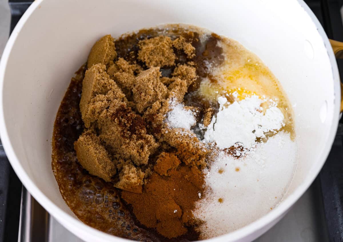 Overhead shot of butter sugars and spices in a saucepan. 