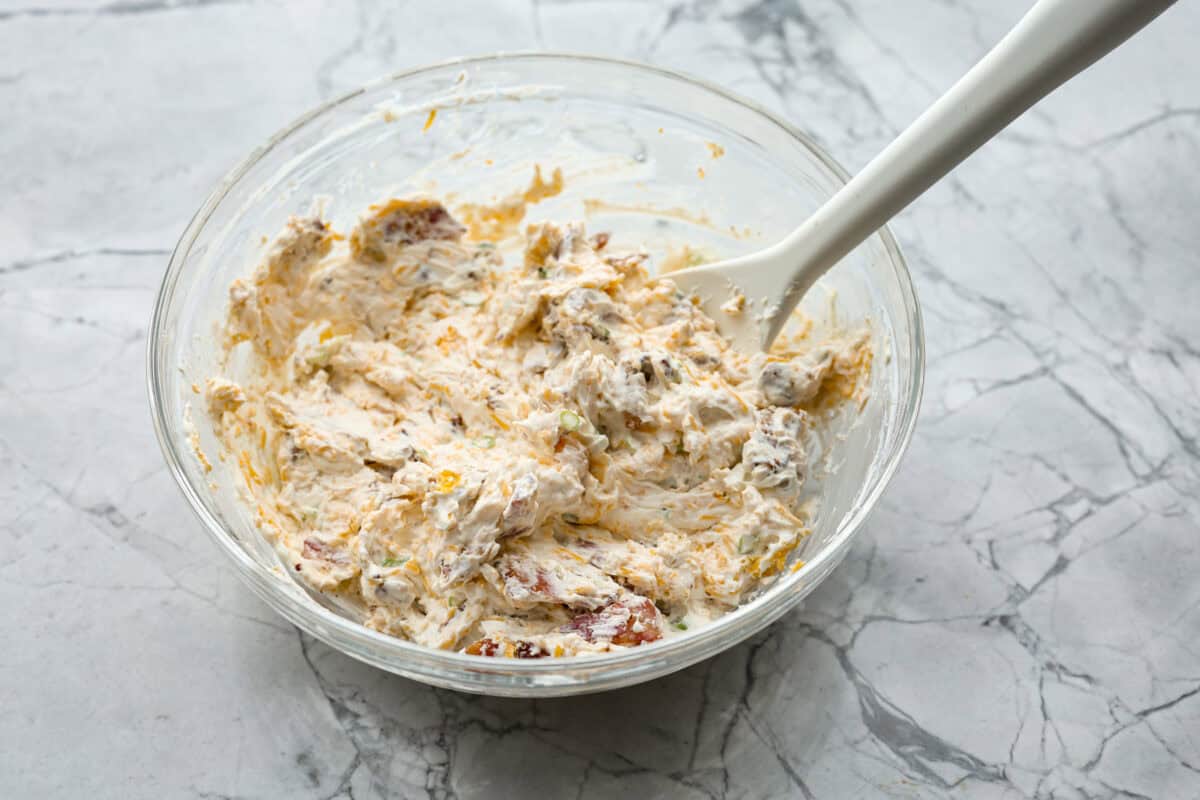 Overhead shot of cream cheese topping mixture in a glass bowl. 