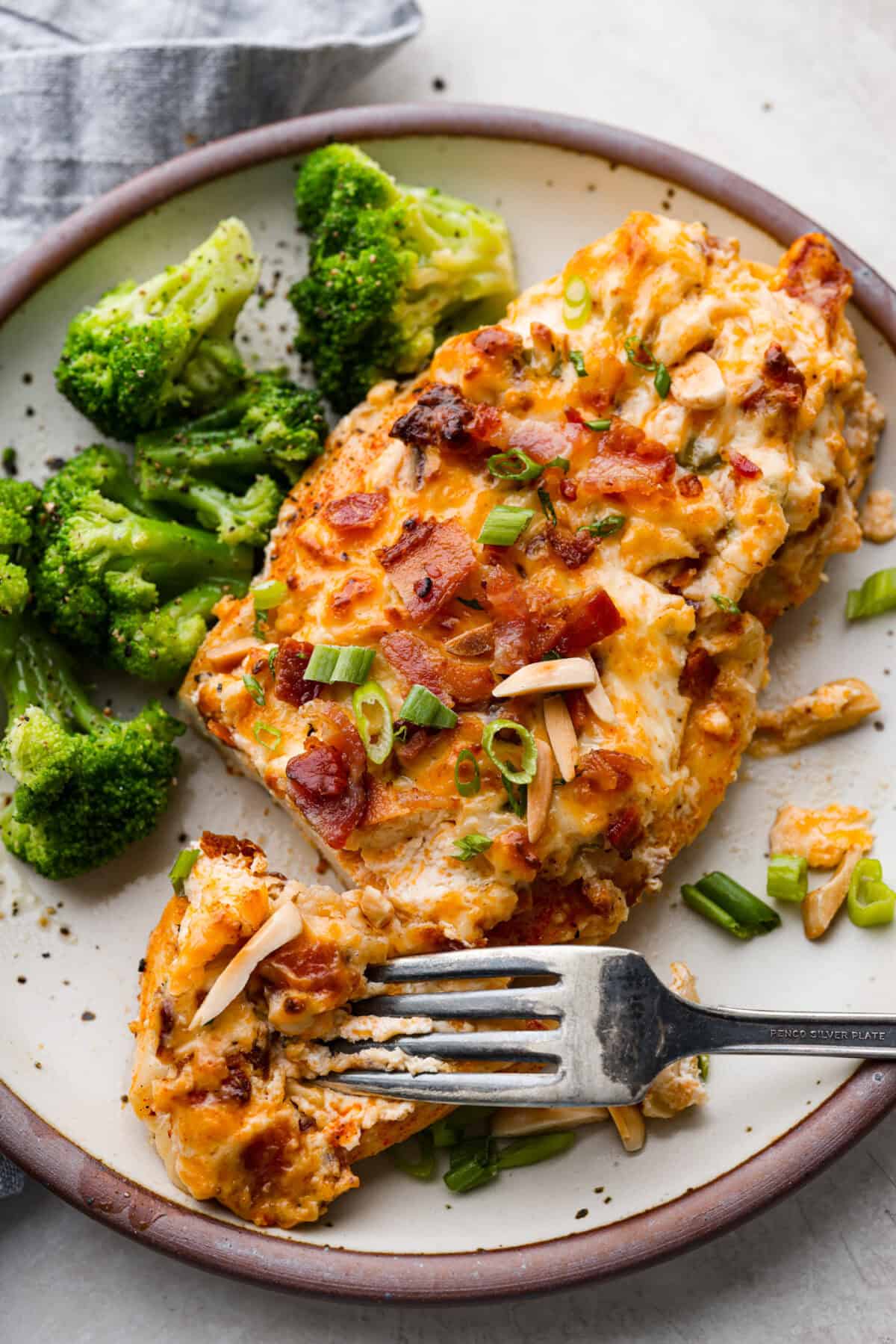 Overhead shot of plated million dollar chicken with a side of broccoli. 