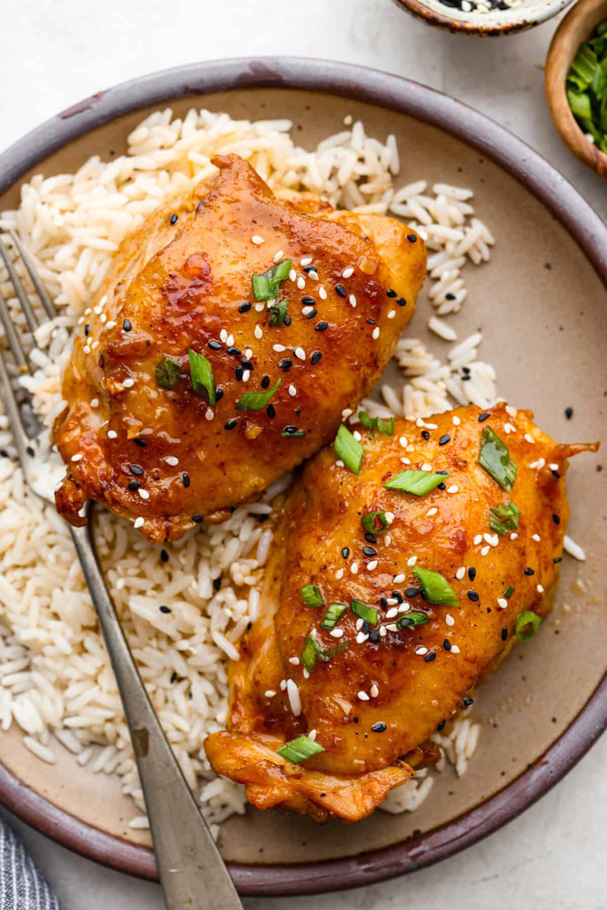 Overhead shot of plated miso chicken over a bed or rice.