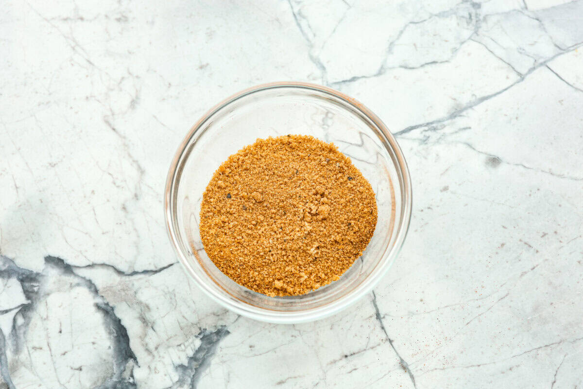 Overhead shot of brown sugar and spices mixed together in a bowl. 