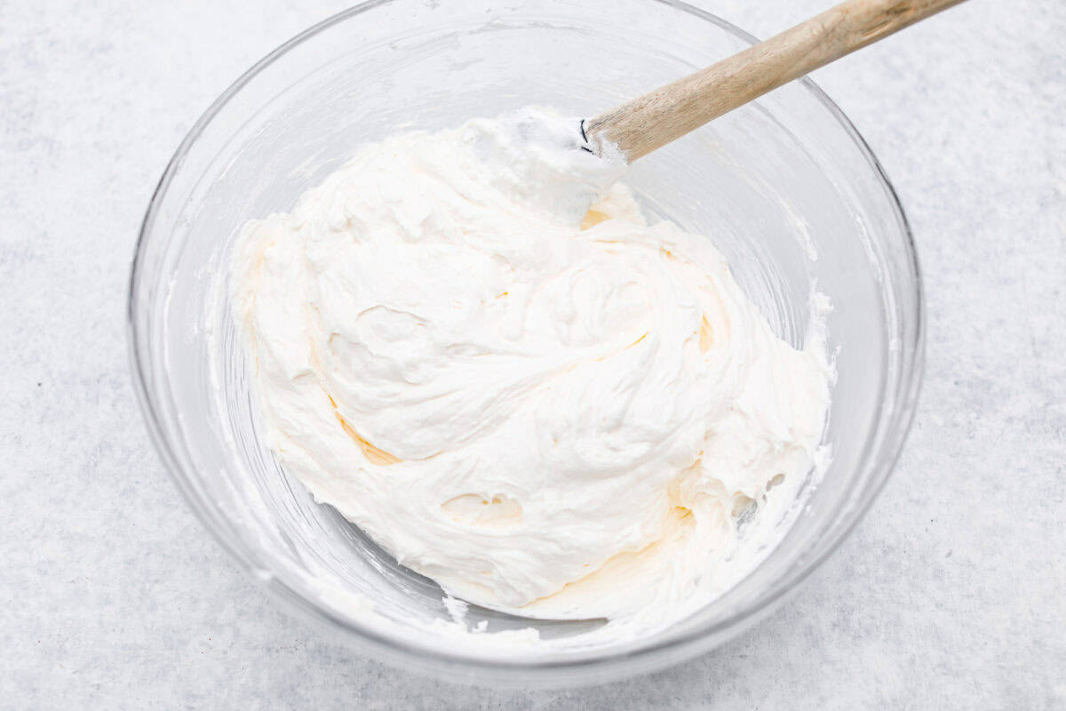 Fifth photo of the whipped topping folding into the cream cheese layer.