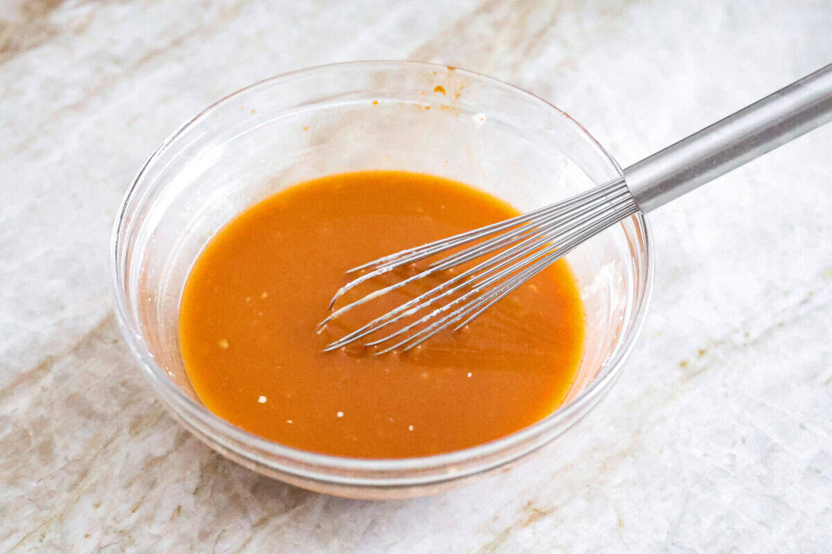 Hunan chicken is a tasty take-out favorite that can be made right at home! Tender chicken and veggies are tossed in the signature hunan sauce. It's savory with a hint of sweet and spicy! This easy one-pan dinner is ready in 30 minutes! Fourth photo of the Hunan sauce mixed in a bowl.