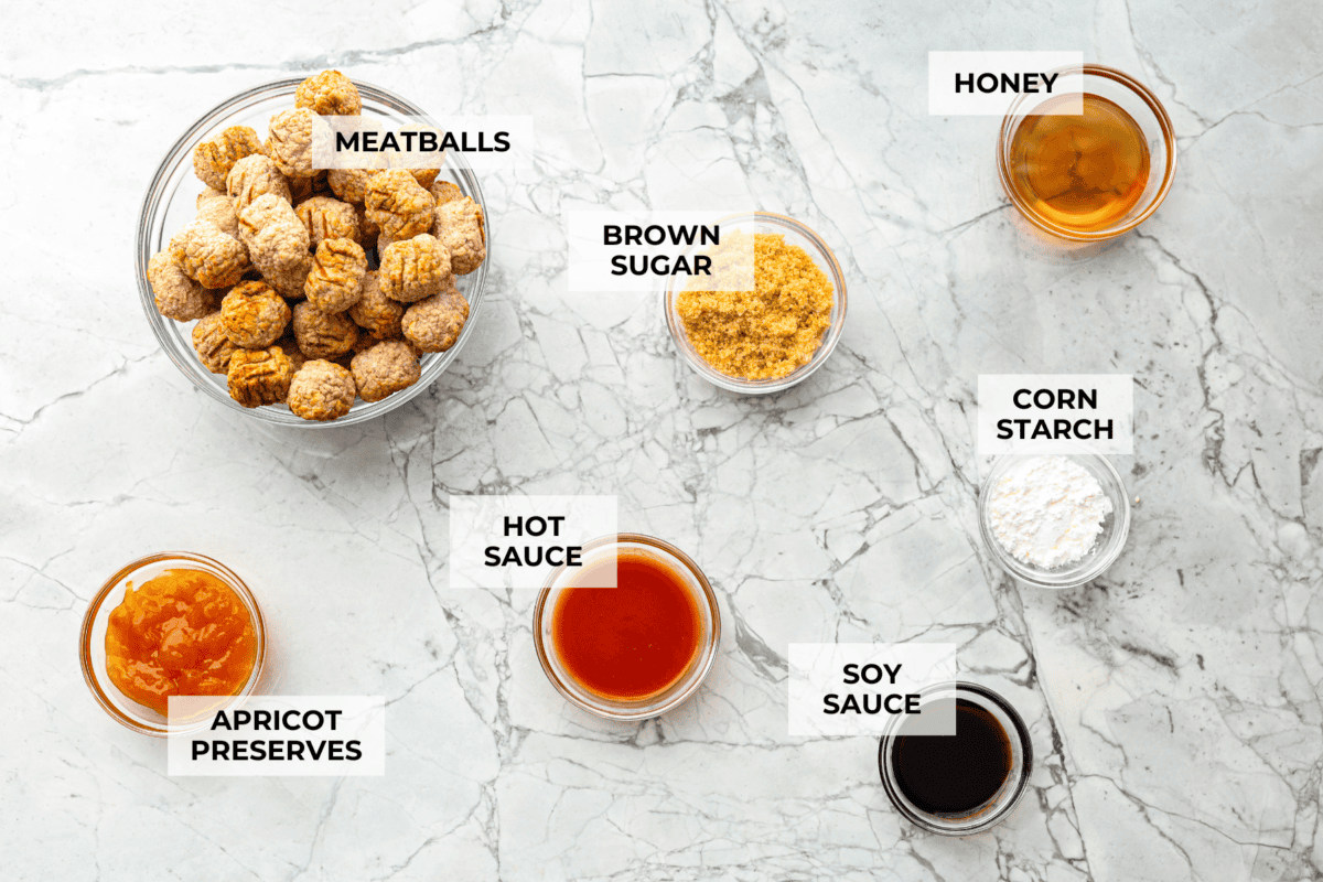 Tender, juicy Slow Cooker Honey Buffalo Meatballs are simmered in the most tantalizing sweet heat sauce that everyone goes crazy for! Perfect appetizer or delicious, easy meal! Overhead shot of labeled ingredients.