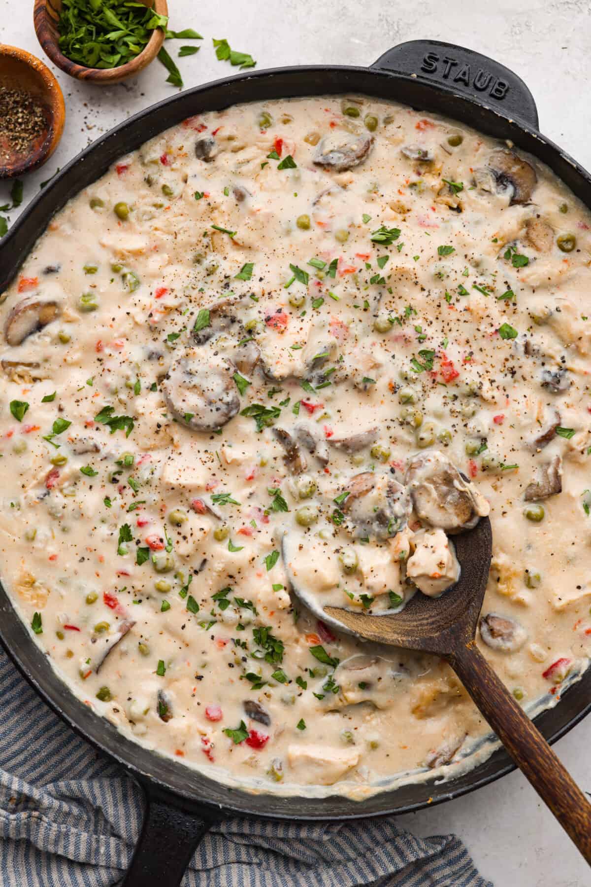 Chicken a la king is a timeless recipe that’s perfect for cozy dinners! This classic dish features tender chicken and veggies in a rich, creamy gravy-like sauce loaded with savory flavor. Overhead shot of chicken a la king in a skillet.