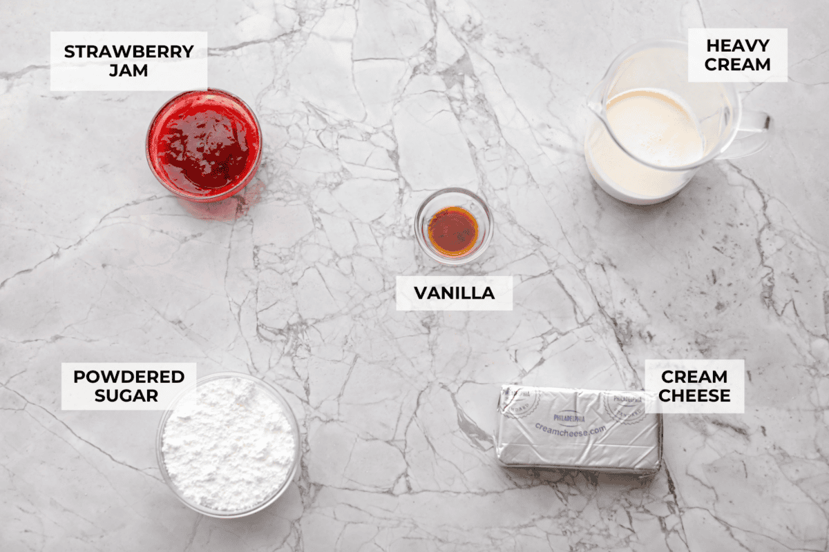 Strawberry cheesecake dip is an irresistible treat that tastes just like the classic but in a fun dip form! Whip it up in just 5 minutes! It's so good with graham crackers, fresh fruit, and cookies for a sweet, crowd-pleasing snack! Overhead shot of labeled ingredients.