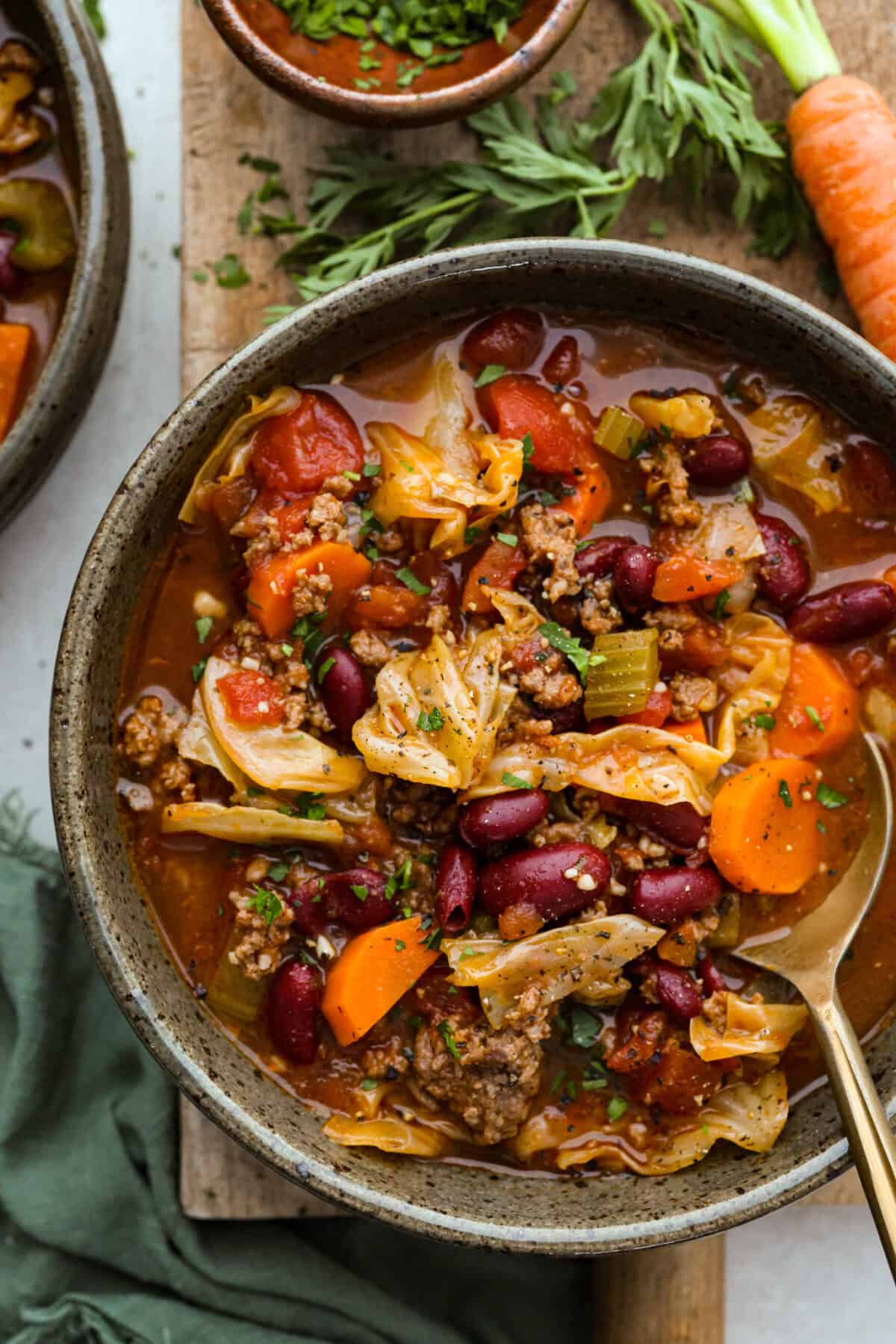 Beef and Cabbage soup is filled with seasoned ground beef, cabbage, carrots, celery, kidney beans, and diced tomatoes. It is hearty, delicious, and full of flavor! This is a great soup to serve on a cold day or to help you get in the spirit of St. Patrick's Day while keeping your nutrition goals in check. Overhead shot of a bowl of beef and cabbage soup.
