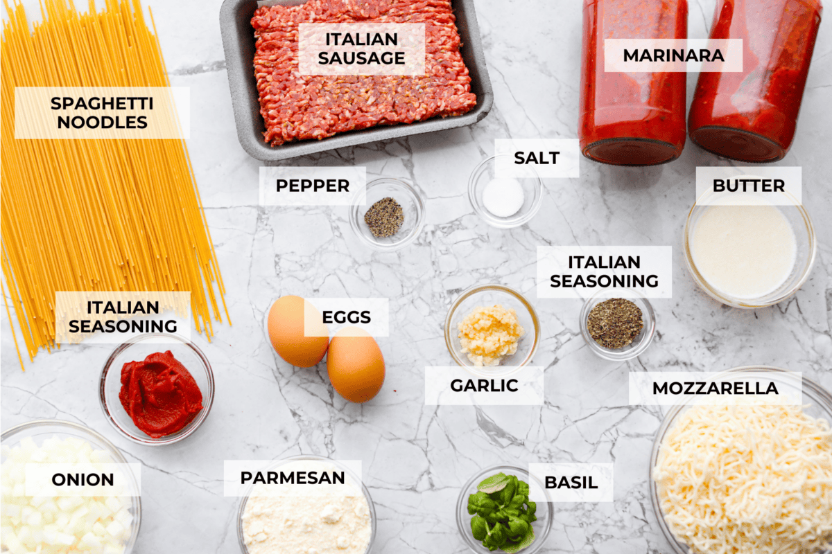 Baked spaghetti is the ultimate comfort food, with noodles that soak up all of the rich sauce as they finish cooking, making every bite extra flavorful. Plus, it’s a lifesaver on busy days. You can prep it ahead, pop it in the oven, and still have a cozy, home-cooked meal without the stress! Overhead shot of labeled baked spaghetti ingredients.