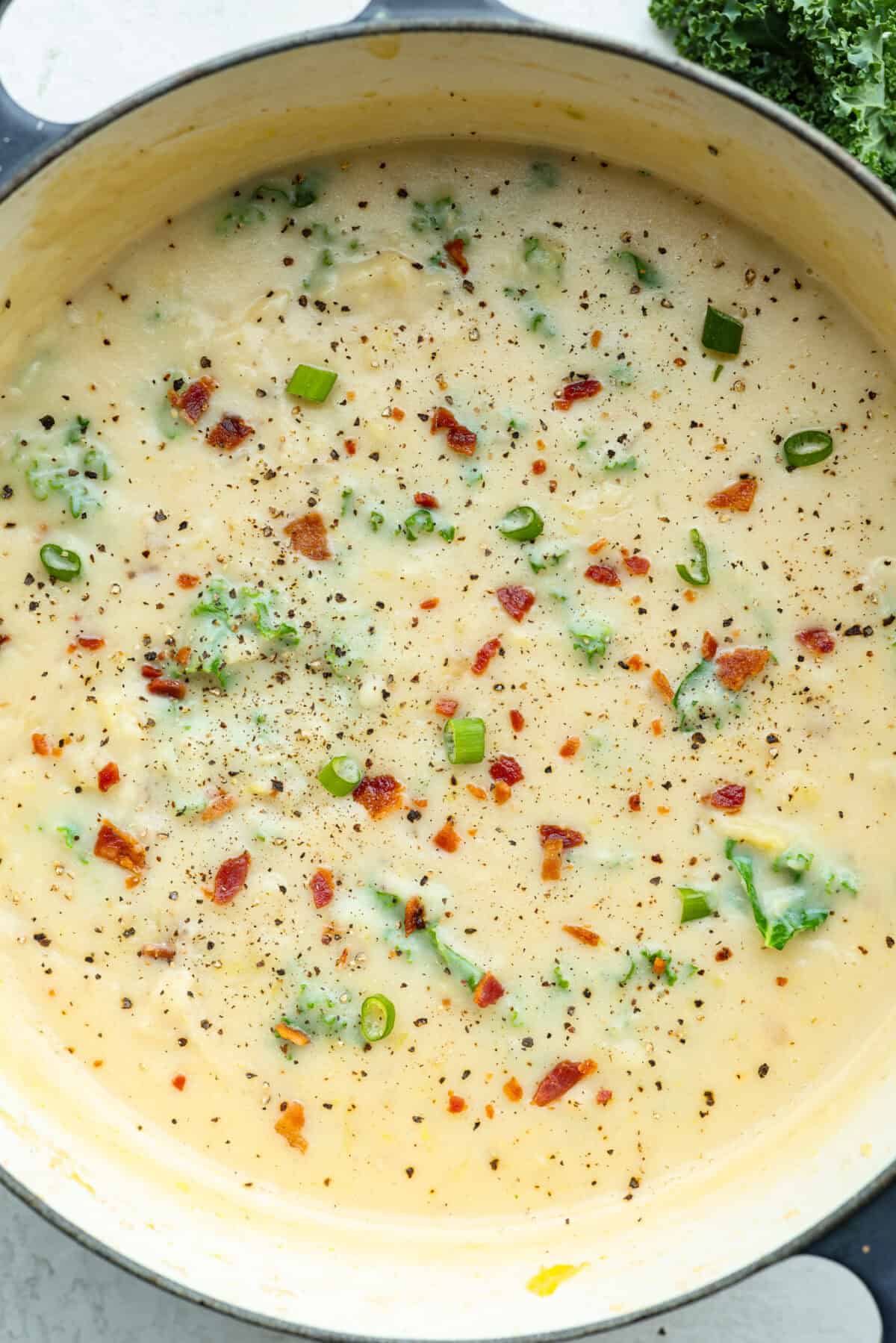 This colcannon soup is a creamy, luscious soup inspired by the traditional Irish dish that is made with potatoes, cabbage, kale, butter, and cream. This would be a great recipe to start a St. Patrick's Day tradition with your family. Overhead shot of colcannon soup in a pot.