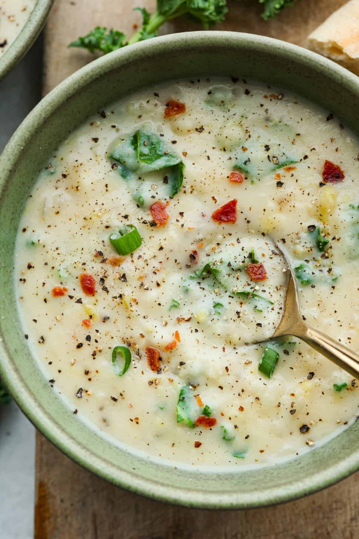 This colcannon soup is a creamy, luscious soup inspired by the traditional Irish dish that is made with potatoes, cabbage, kale, butter, and cream. This would be a great recipe to start a St. Patrick's Day tradition with your family. Overhead shot of a bowl of colcannon soup.