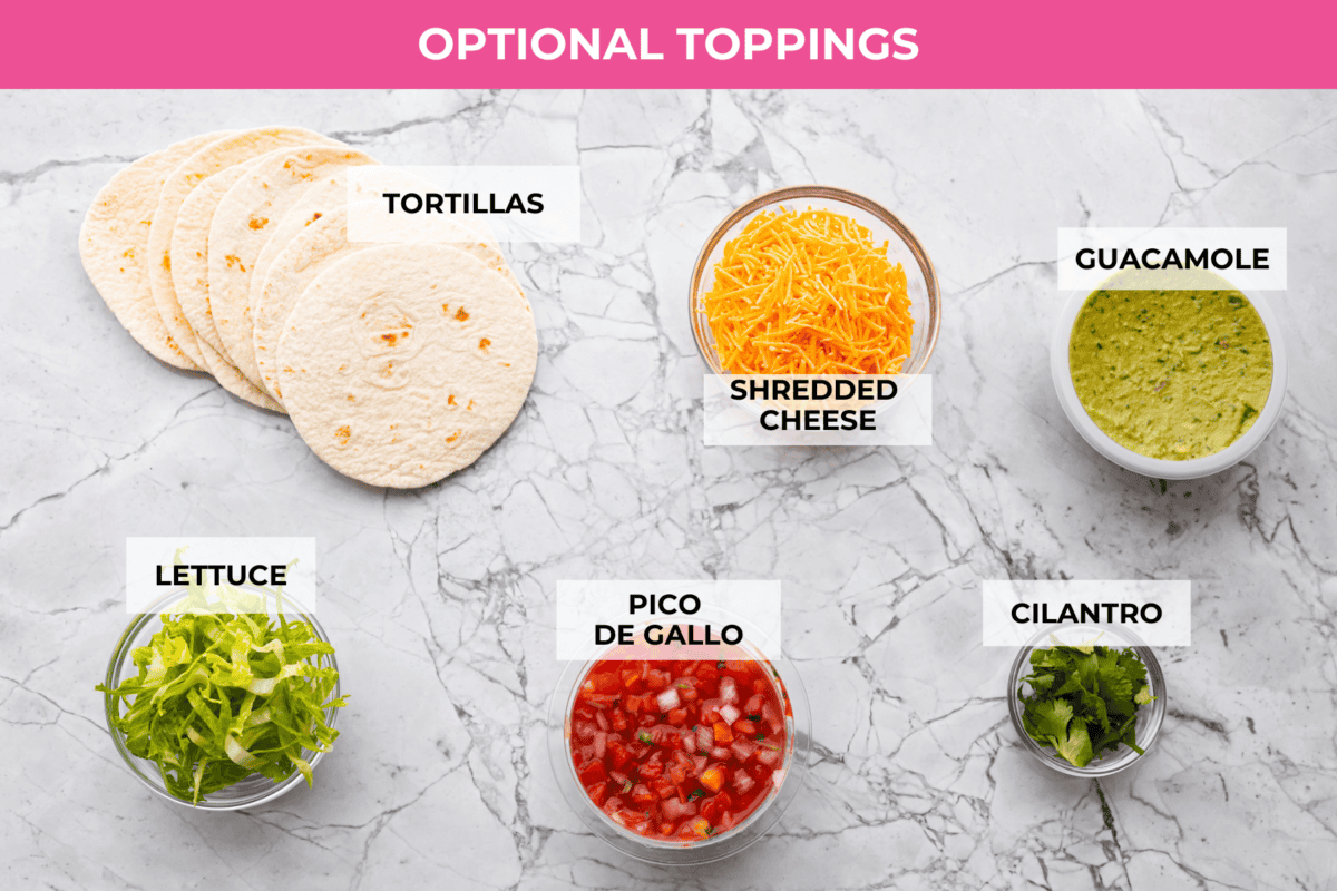 These ground turkey tacos are full of fiesta flavor, all with less fat! Don't let ground turkey steer you away! No one will miss the beef once they taste this taco filling. The seasonings and flavors absorb perfectly into the meat. Overhead shot of labeled topping option ingredients.
