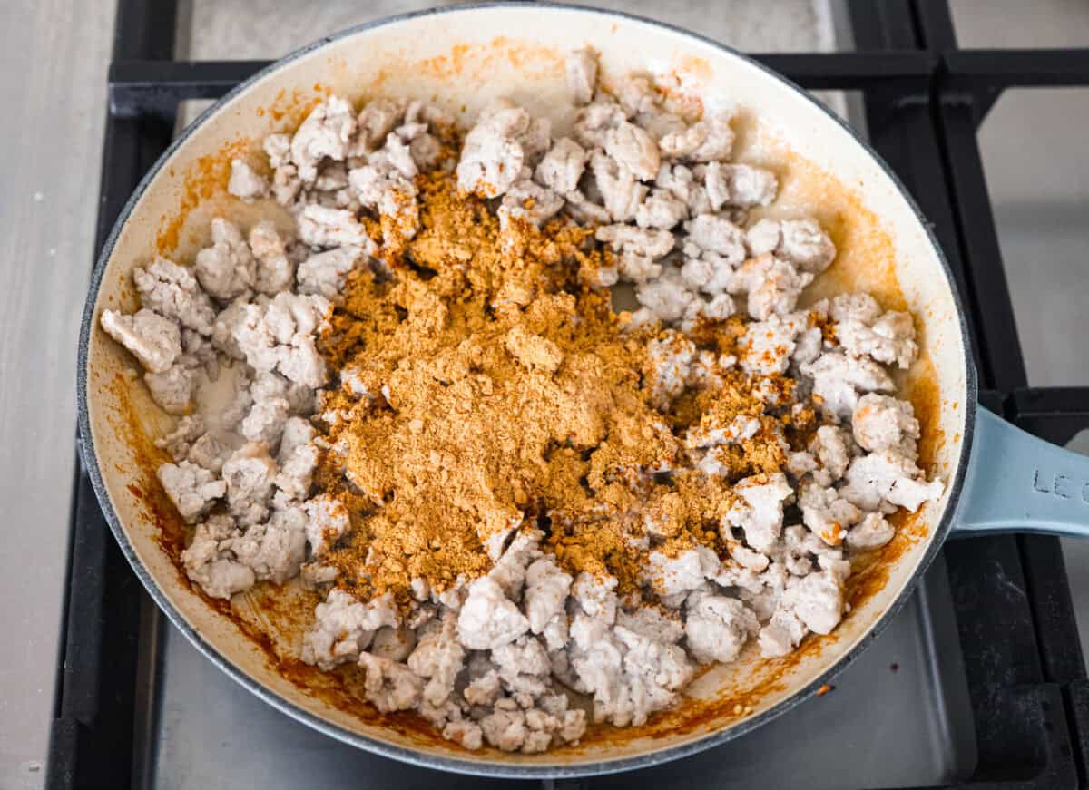 These ground turkey tacos are full of fiesta flavor, all with less fat! Don't let ground turkey steer you away! No one will miss the beef once they taste this taco filling. The seasonings and flavors absorb perfectly into the meat. Overhead shot of cooking ground turkey with taco seasoning added to it.