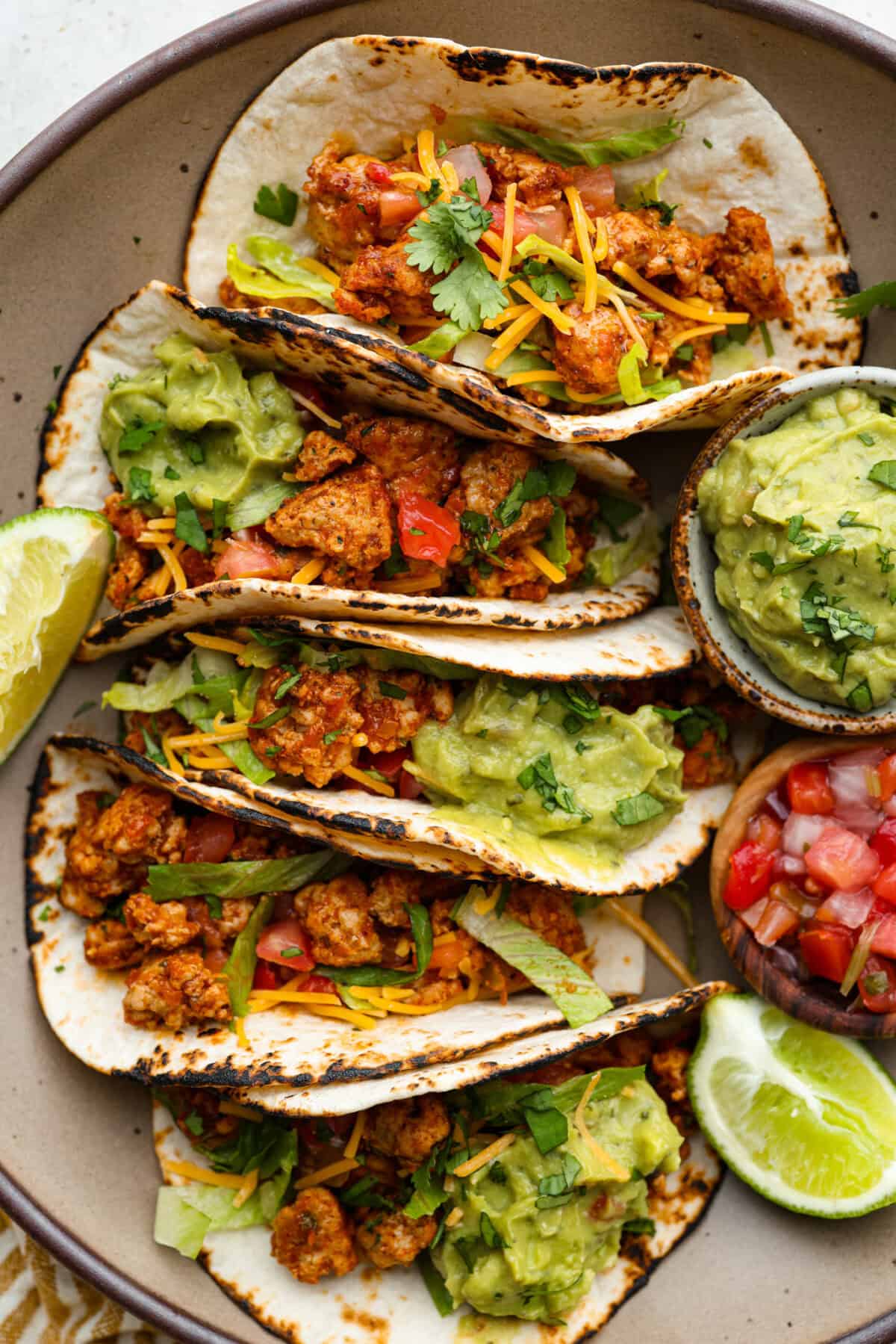 These ground turkey tacos are full of fiesta flavor, all with less fat! Don't let ground turkey steer you away! No one will miss the beef once they taste this taco filling. The seasonings and flavors absorb perfectly into the meat. Overhead shot of ground turkey tacos.
