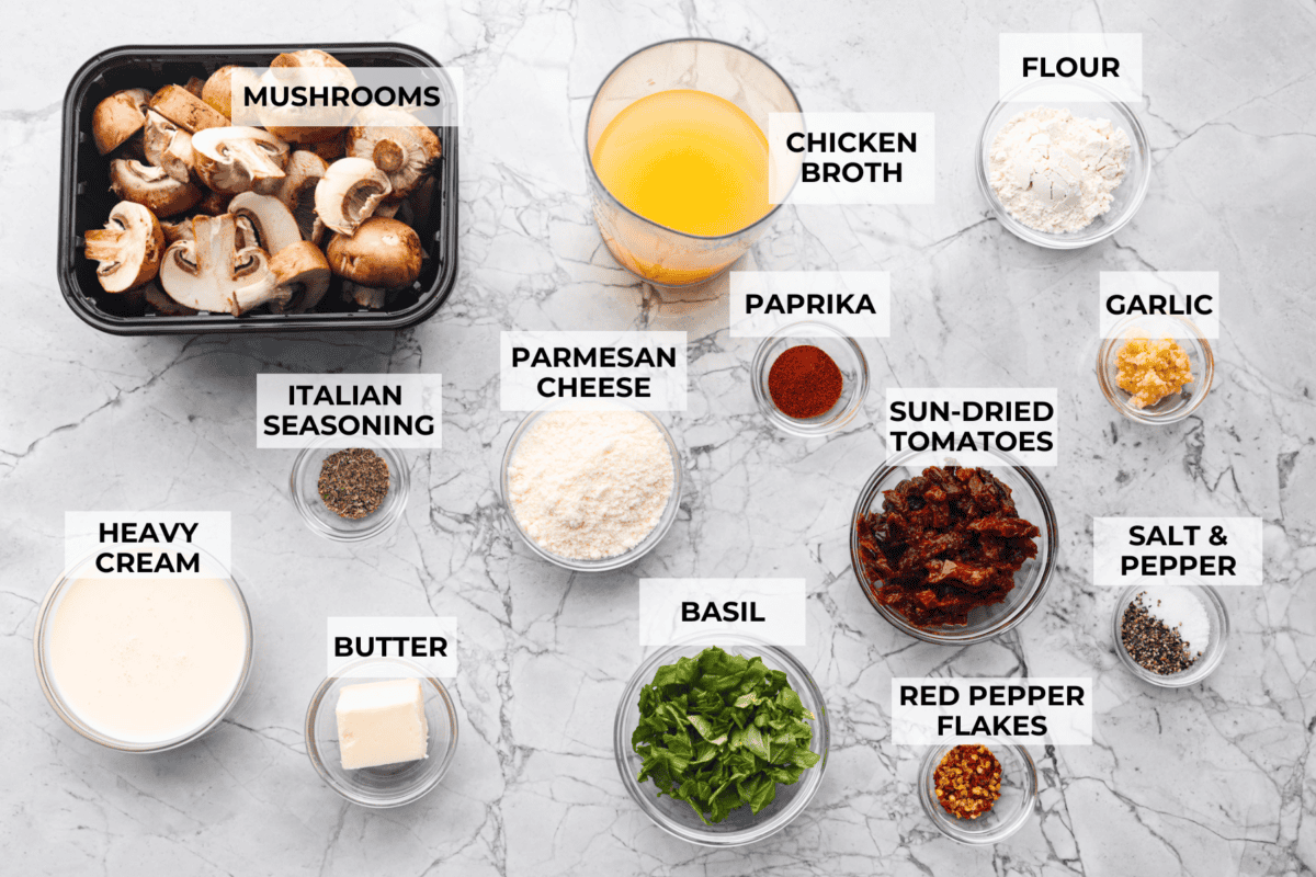 The key to making these Marry Me Mushrooms irresistibly flavorful is getting the perfect sear on the mushrooms. This locks in their natural flavors and texture. Then they simmer in a creamy garlic parmesan sauce with robust sun-dried tomatoes and herbs. It’s a simple technique that makes all the difference! Overhead shot of labeled ingredients.