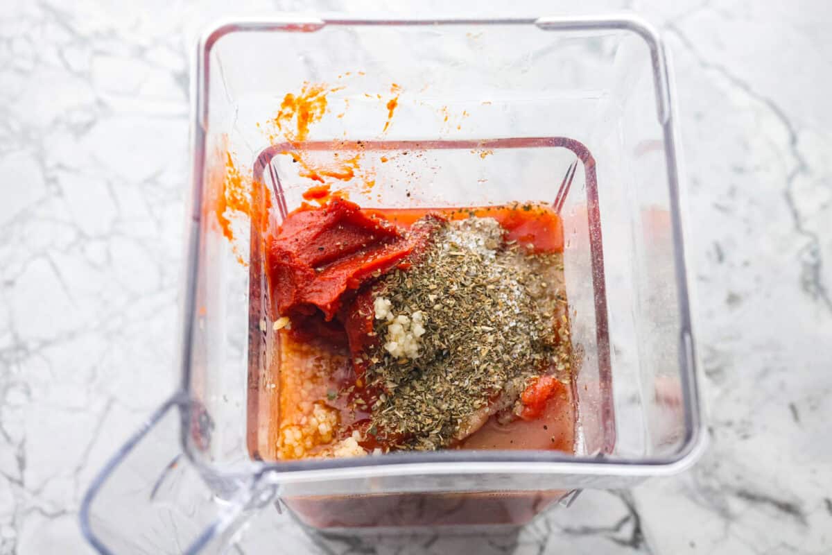 After re-testing this Homemade Marinara Sauce, I can confidently say it’s the BEST! You can make it in 15 minutes, but letting it simmer makes the flavors even better! Marinara sauce ingredients added to a blender.