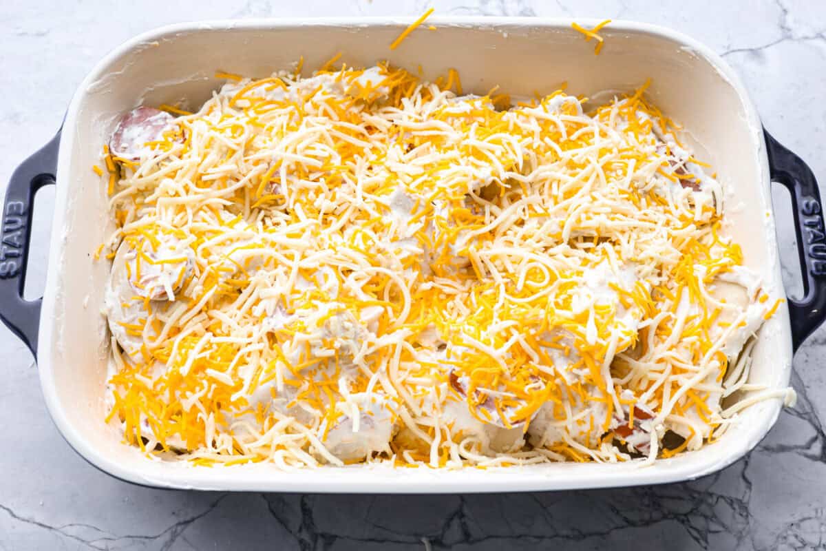 This isn’t your average Pierogi Casserole. While most stick to one type of cheese, I use a blend for ooey-gooey cheesy creaminess and cozy flavor in every bite. Pierogi casserole ingredients mixed together ready to go in the oven.