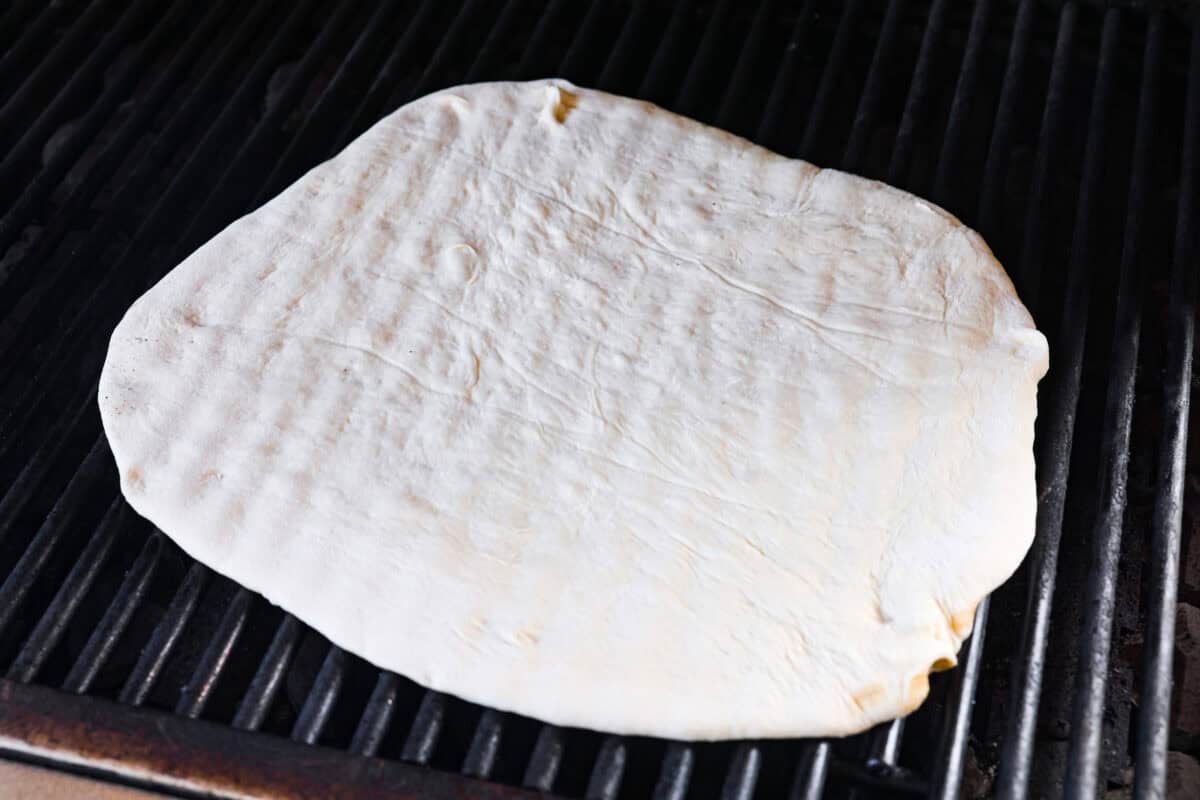 I’m all about pizza and grilling, so when I can combine the two, it’s a win. The grill gives pizza that smoky, crispy flavor you can’t get from the oven. Trust me, this grilled pizza will have you hooked! Pizza dough on the grill.