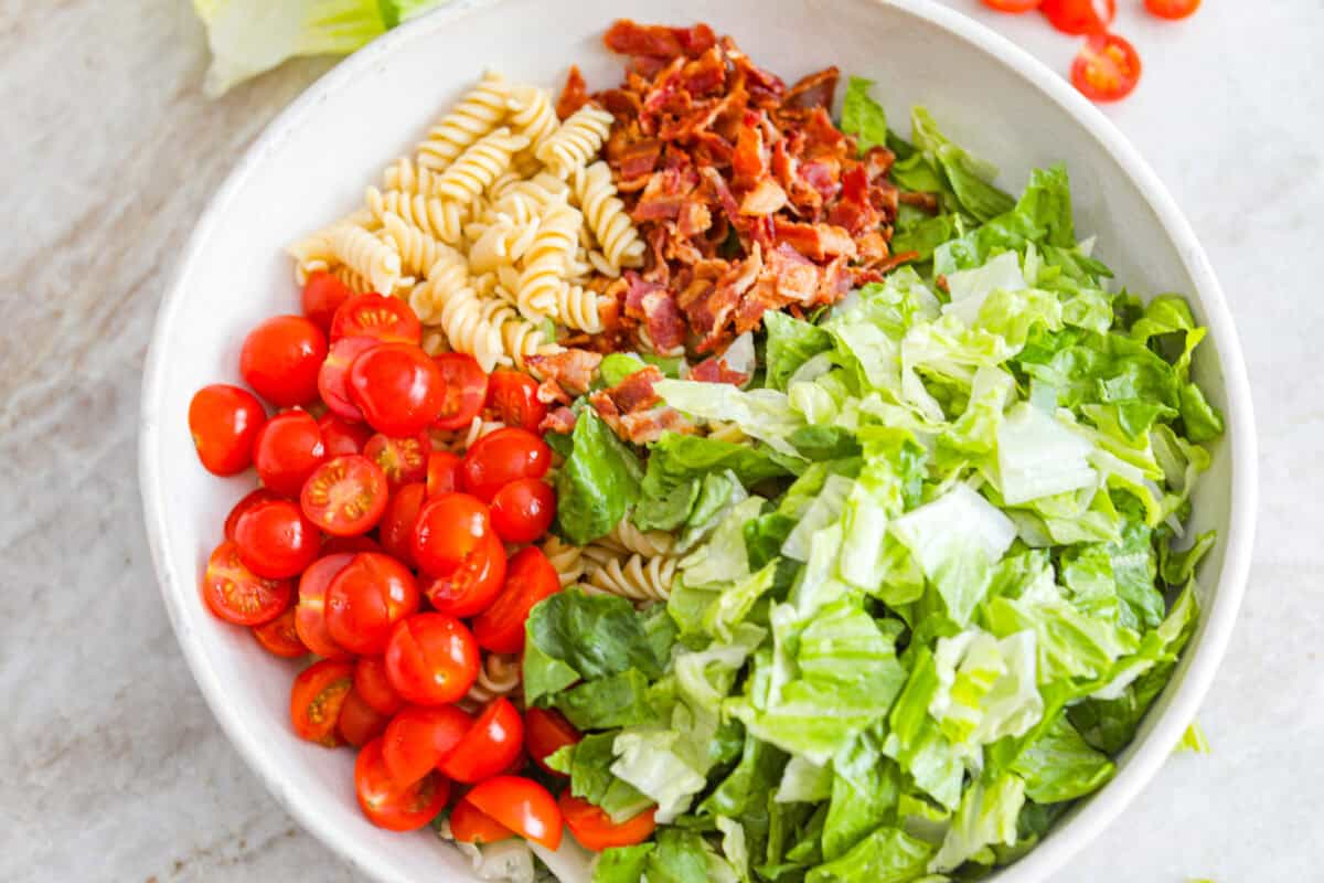 The best sandwich ever? Hands down, a BLT. Add in my obsession with pasta salads and, chef’s kiss! This BLT Pasta Salad has the crispy bacon, juicy tomatoes, and crunchy lettuce we all love! Bowl with pasta, lettuce, bacon, and tomatoes.
