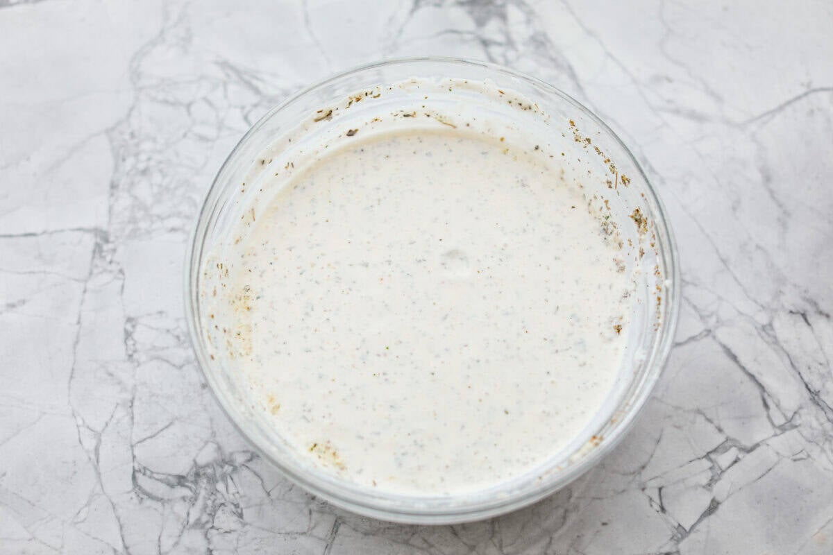 The best sandwich ever? Hands down, a BLT. Add in my obsession with pasta salads and, chef’s kiss! This BLT Pasta Salad has the crispy bacon, juicy tomatoes, and crunchy lettuce we all love! Bowl with Ranch dressing ingredients mixed together.