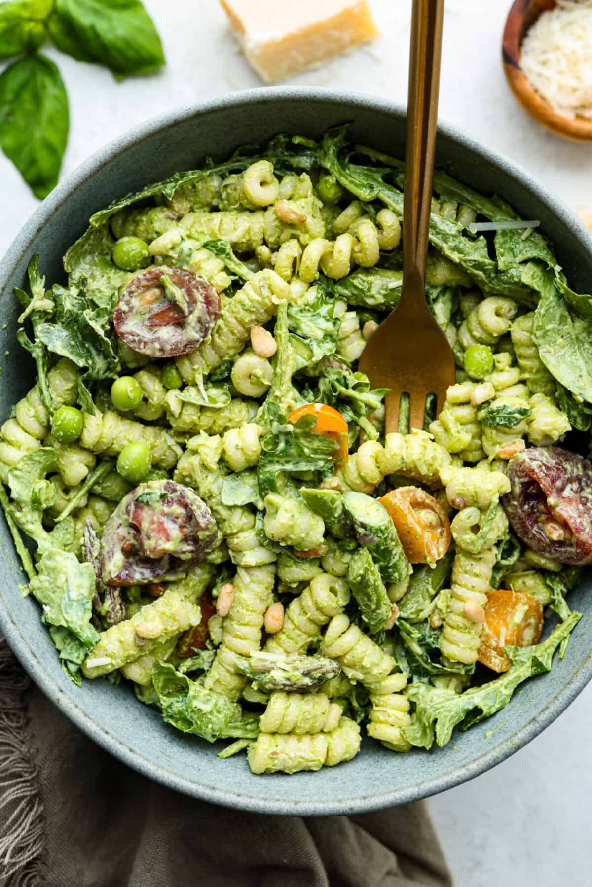 This Green Goddess Pasta Salad is fresh, vibrant, and full of flavor! The creamy herb dressing adds a tangy twist, while crisp spring veggies make it light yet hearty. Perfect for potlucks or any time you’re craving a delicious side! Overhead shot of a bowl of green goddess pasta salad.