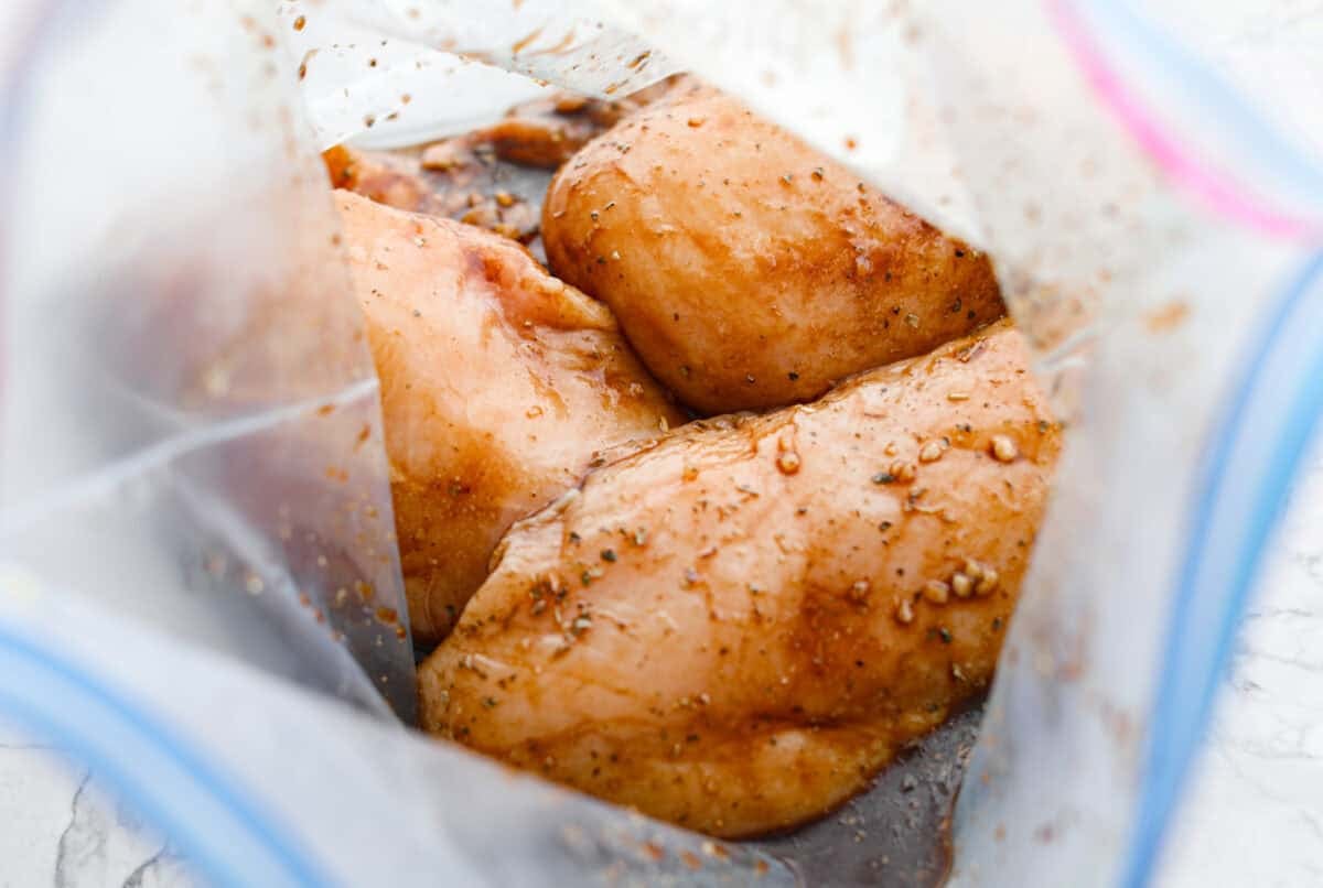 I’ve been on a balsamic kick lately. Drizzling it on salads, veggies, and even watermelon! But this Balsamic Chicken marinade is pure magic. It’s tangy, a little sweet, and somehow makes everyday chicken taste incredible! Marinade in a bag with raw chicken breasts added to it and coated in the marinade.