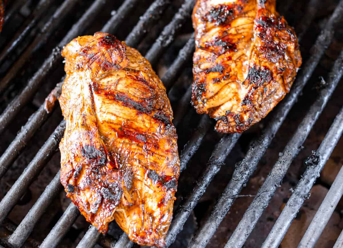 I’ve been on a balsamic kick lately. Drizzling it on salads, veggies, and even watermelon! But this Balsamic Chicken marinade is pure magic. It’s tangy, a little sweet, and somehow makes everyday chicken taste incredible! Marinated chicken cooking on the grill.
