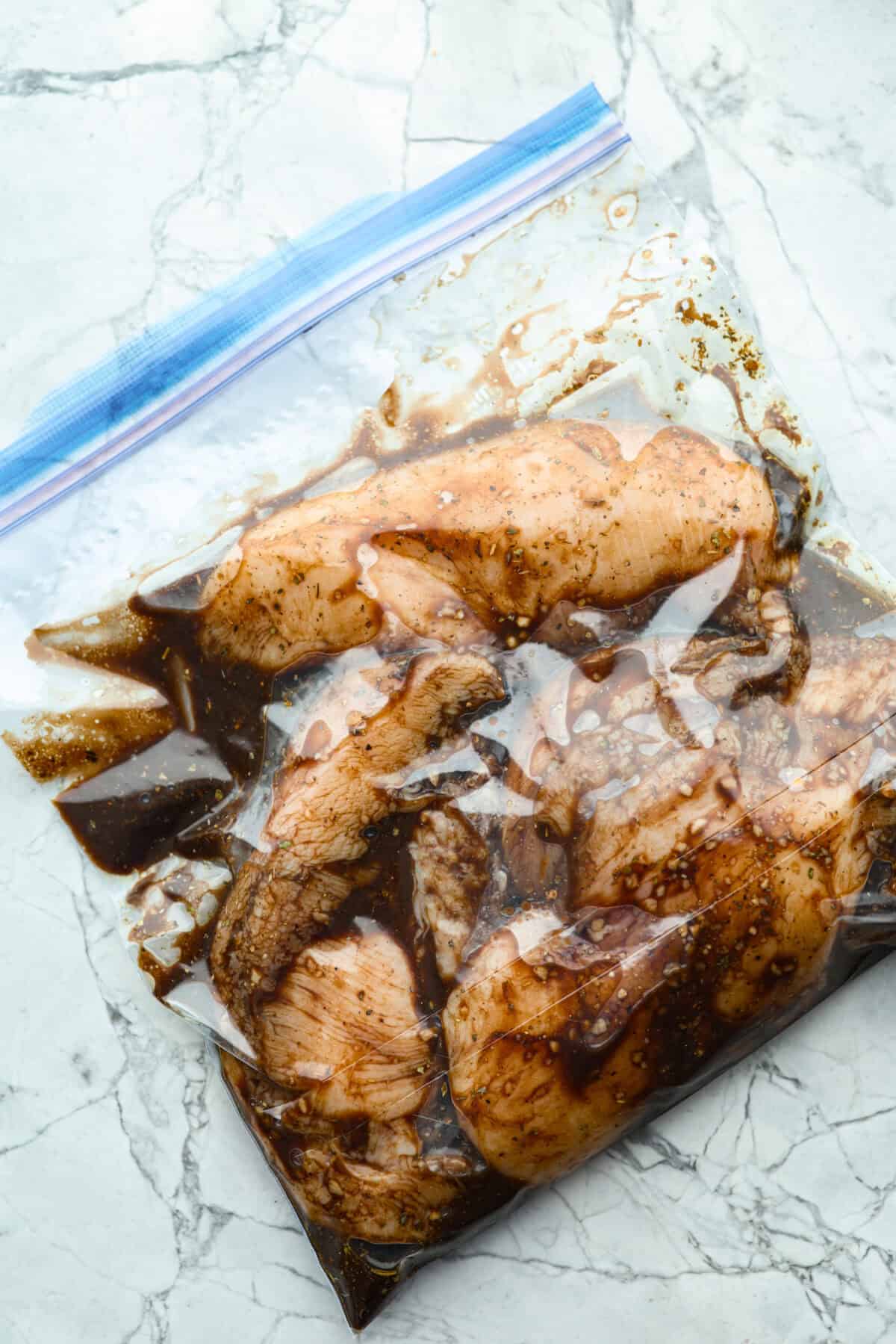 I’ve been on a balsamic kick lately. Drizzling it on salads, veggies, and even watermelon! But this Balsamic Chicken marinade is pure magic. It’s tangy, a little sweet, and somehow makes everyday chicken taste incredible! Bag of raw chicken in the balsamic chicken marinade.