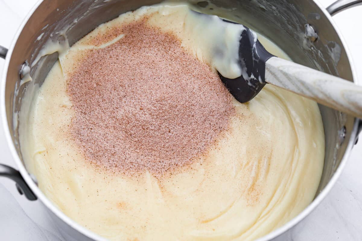 This 4-ingredient churro fudge is pure magic! It's buttery, cinnamon sugary bliss that tastes like a churro and fudge had a baby. It’s easy to make and even easier to gift (if you can resist eating it all first!). Cinnamon and sugar added to the melted chocolate mixture.
