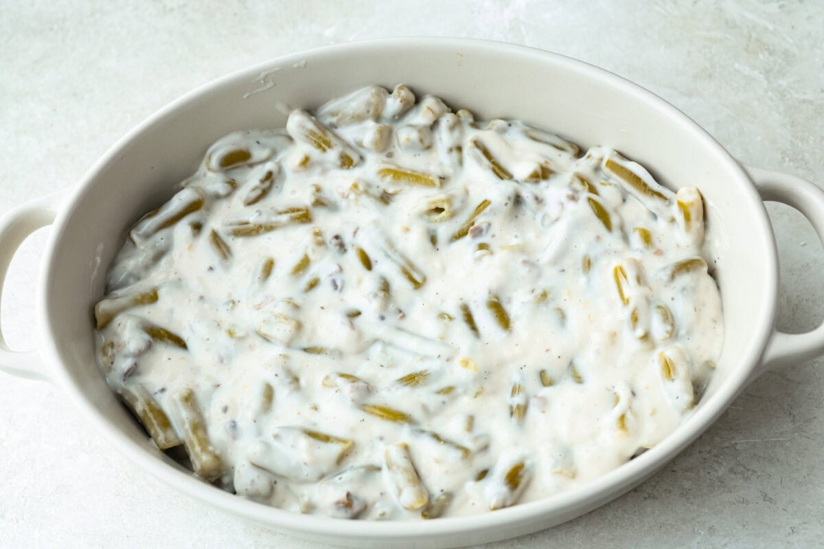 Thanksgiving doesn’t have to mean a long grocery list or an expensive spread. This 5-ingredient green bean casserole keeps things simple, affordable, and classic. It’s proof that comfort food doesn’t need a dozen ingredients. Ingredients added to the baking dish.