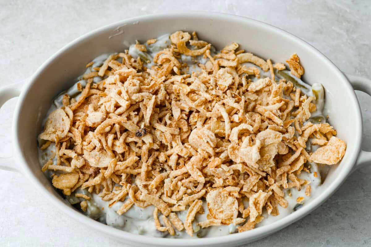 Thanksgiving doesn’t have to mean a long grocery list or an expensive spread. This 5-ingredient green bean casserole keeps things simple, affordable, and classic. It’s proof that comfort food doesn’t need a dozen ingredients. Crispy onions added to the top of the green bean and soup mixture.