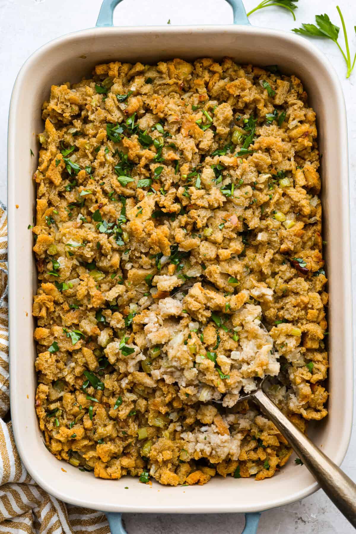 This 5-ingredient stuffing has the same buttery, herby taste as the traditional recipe. All the flavor of classic Thanksgiving stuffing on a budget! You don’t need a long ingredient list to get big holiday flavor. Overhead shot of baked 5-ingredient stuffing.
