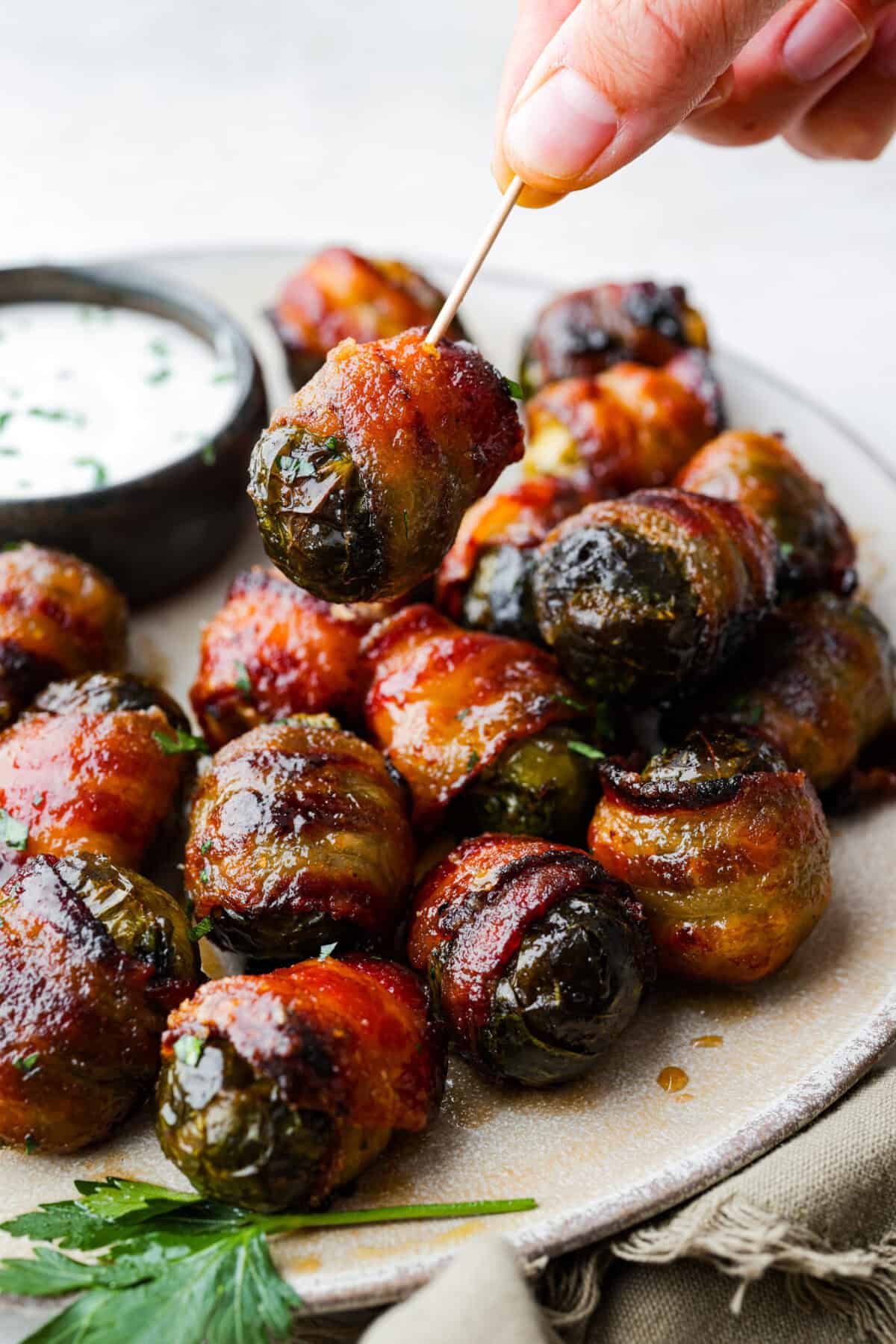 I love bacon. I love Brussels sprouts. Put them together and I’m sold. Atoothpick in a bacon wrapped brussel sprout.