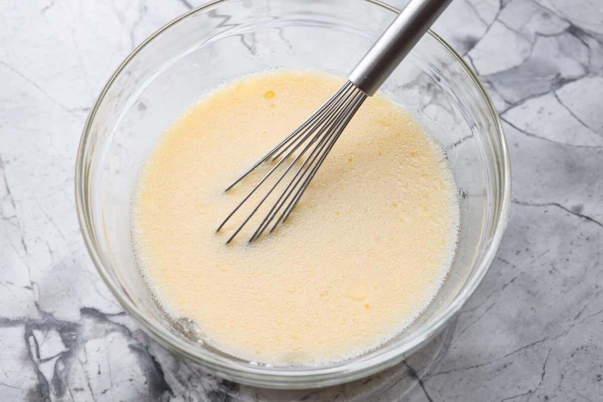 Wet ingredients added to a bowl and whisked together. 
