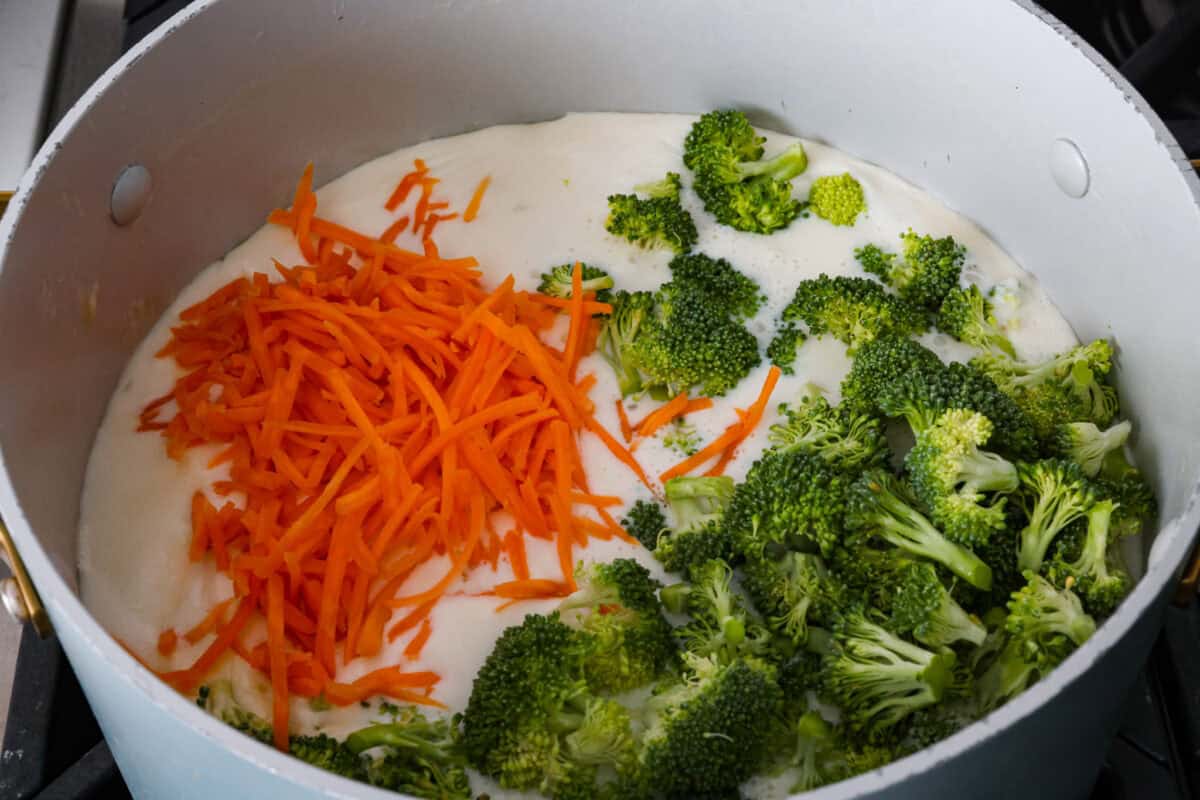 Broccoli and carrots added to the soup base.