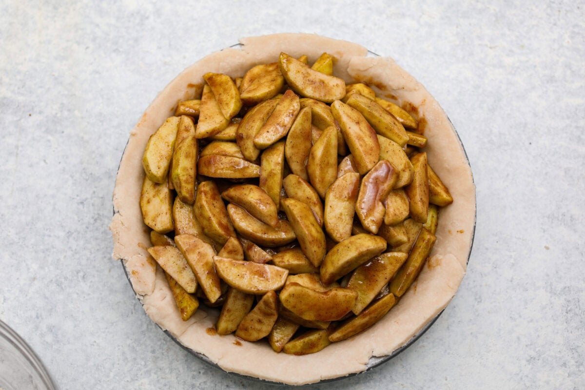 Apple filling added to the pie crust. 