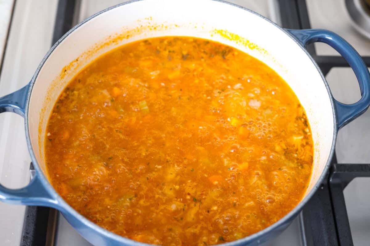 Broth and seasonings added to the pot. 