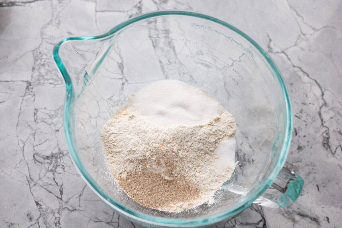 These Caramel Apple Cinnamon Rolls are soft, gooey, and baked with cozy fall flavor in every bite. The homemade dough bakes up perfectly fluffy, and the rich caramel topping makes them feel extra special. Dry ingredients mixed together in a bowl.