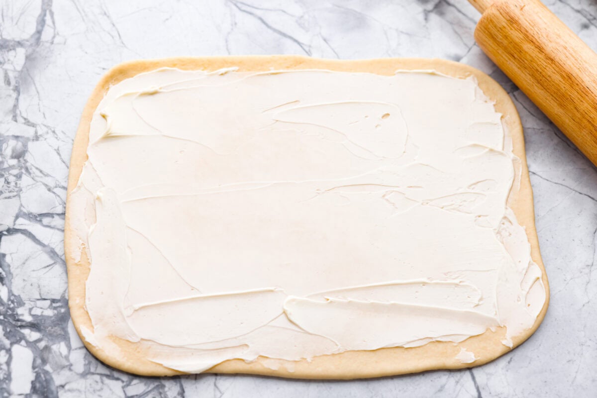 These Caramel Apple Cinnamon Rolls are soft, gooey, and baked with cozy fall flavor in every bite. The homemade dough bakes up perfectly fluffy, and the rich caramel topping makes them feel extra special. Rolled out dough covered in butter.