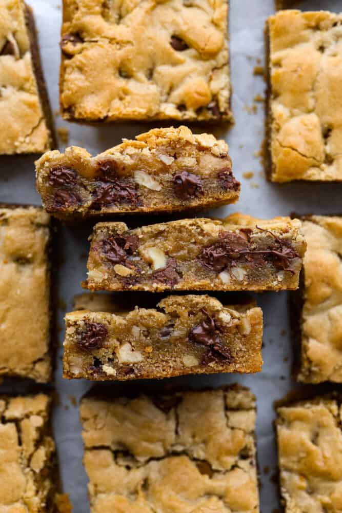 If you’ve never tried a congo bar, they’re basically chocolate chip cookie bars with a little added flair. They’re usually made with chopped nuts or coconut for some extra texture, and let me tell you… They are what dreams are made of. Closeup of congo bars.