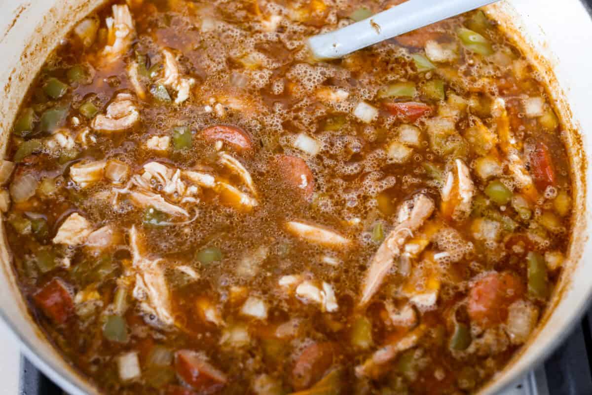 Gumbo is one of those recipes everyone makes differently, but this chicken and sausage gumbo keeps it simple. A dark roux, andouille sausage, and rotisserie chicken give you big flavor with minimal effort. All of the ingredients simmering in a big pot on the stove.