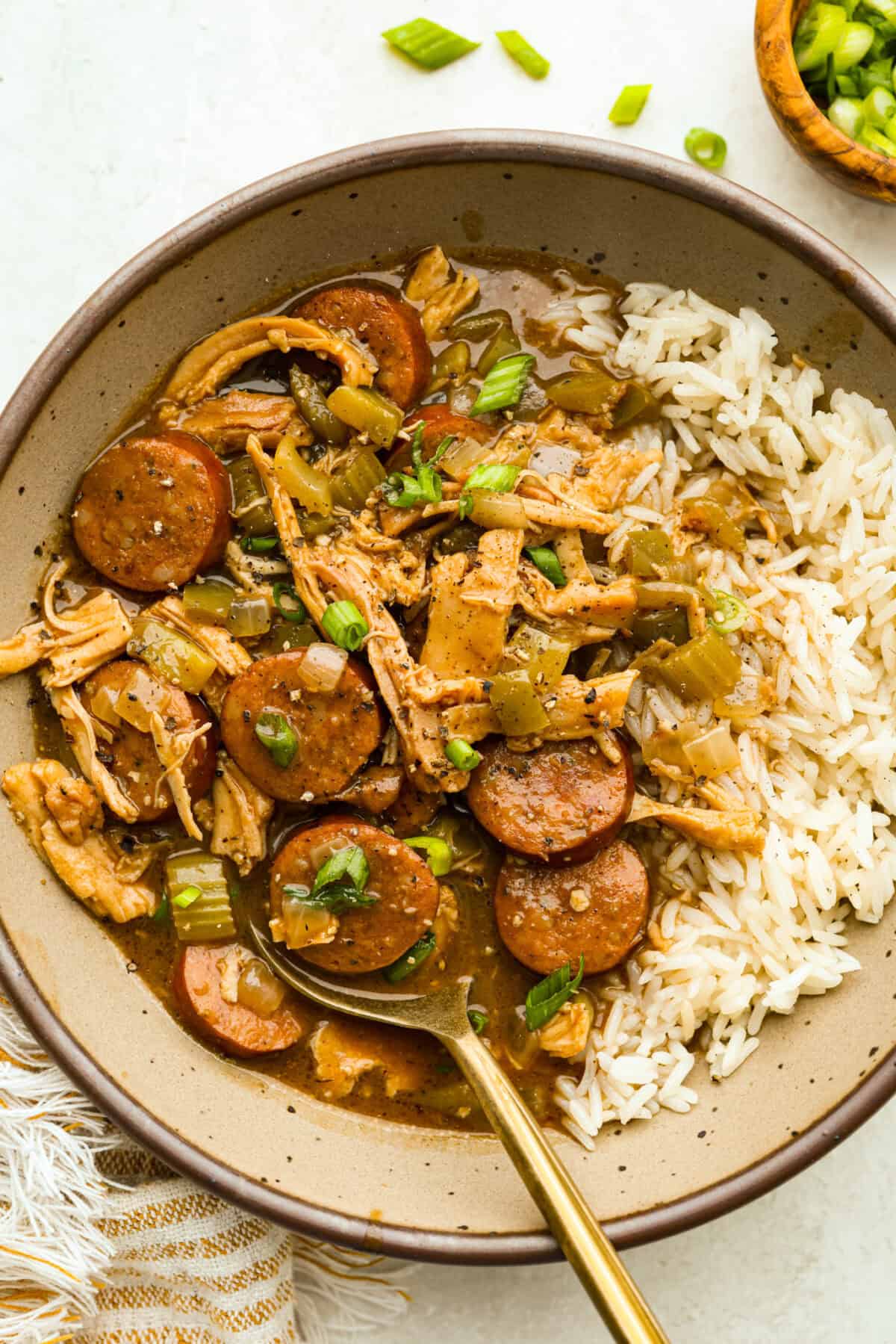 Gumbo is one of those recipes everyone makes differently, but this chicken and sausage gumbo keeps it simple. A dark roux, andouille sausage, and rotisserie chicken give you big flavor with minimal effort. Bowl of chicken and sausage gumbo with white rice.