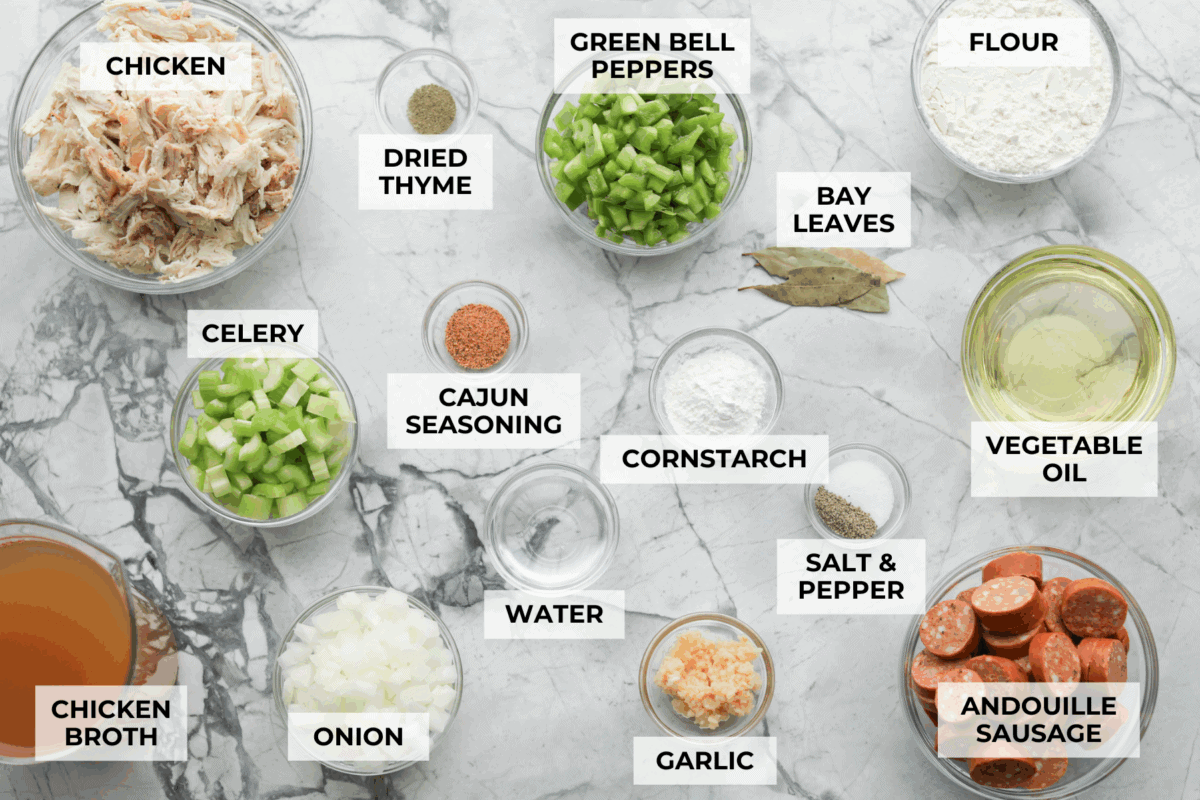 Gumbo is one of those recipes everyone makes differently, but this chicken and sausage gumbo keeps it simple. A dark roux, andouille sausage, and rotisserie chicken give you big flavor with minimal effort. Overhead shot of labeled chicken and sausage gumbo ingredients.
