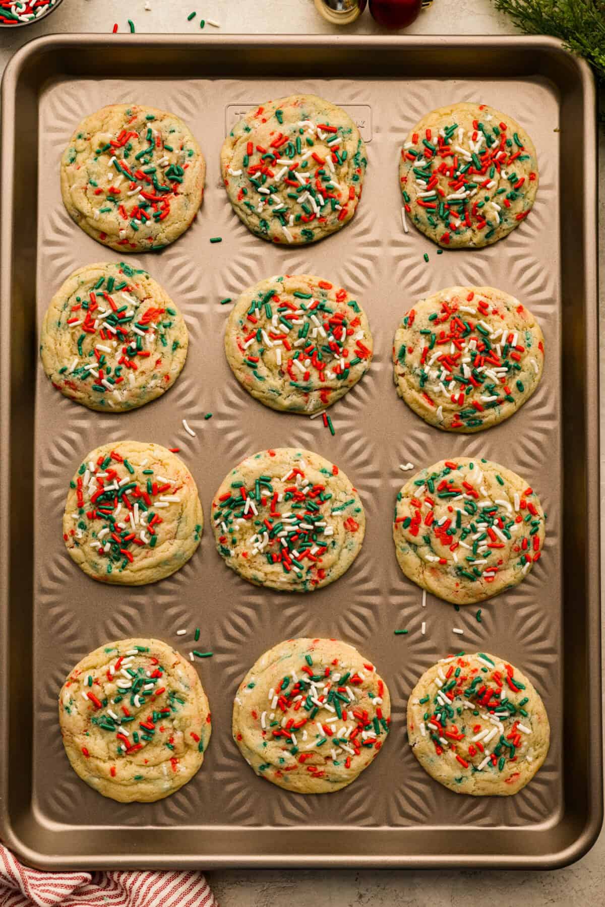Sprinkle cookies baked and cooling on the cookie sheet.