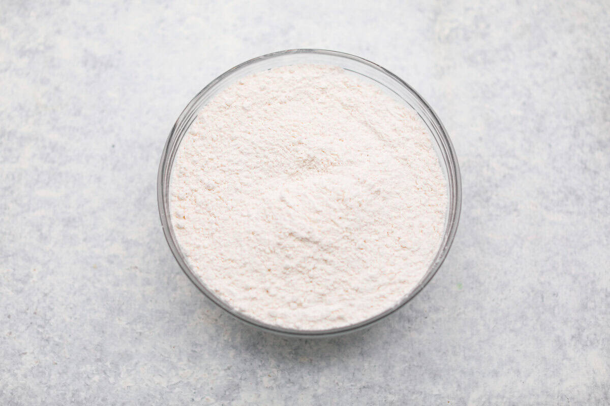 This sour cream pound cake is buttery, moist, and so tender. The light vanilla flavor with a little tang from the sour cream makes it delicious on its own, or even better with berries, whipped cream, or ice cream. Dry ingredients sifted in a bowl.