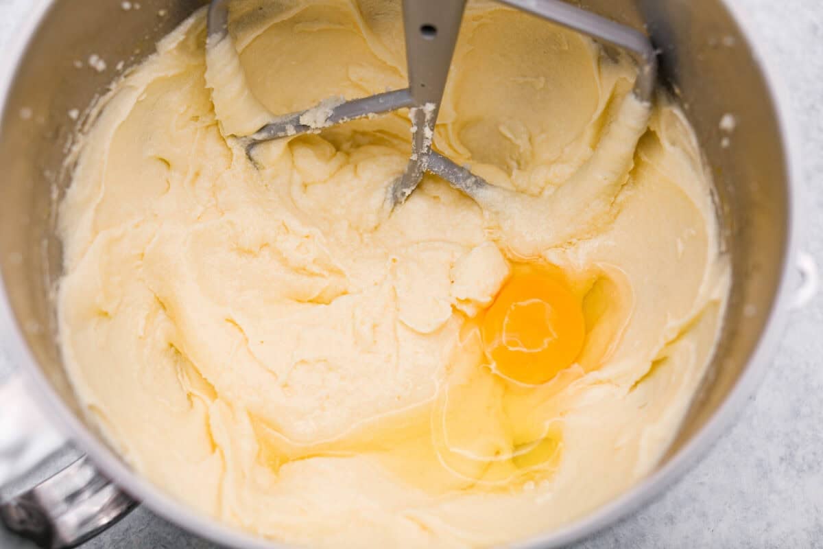 This sour cream pound cake is buttery, moist, and so tender. The light vanilla flavor with a little tang from the sour cream makes it delicious on its own, or even better with berries, whipped cream, or ice cream. Eggs being added in to the stand mixer one at a time.