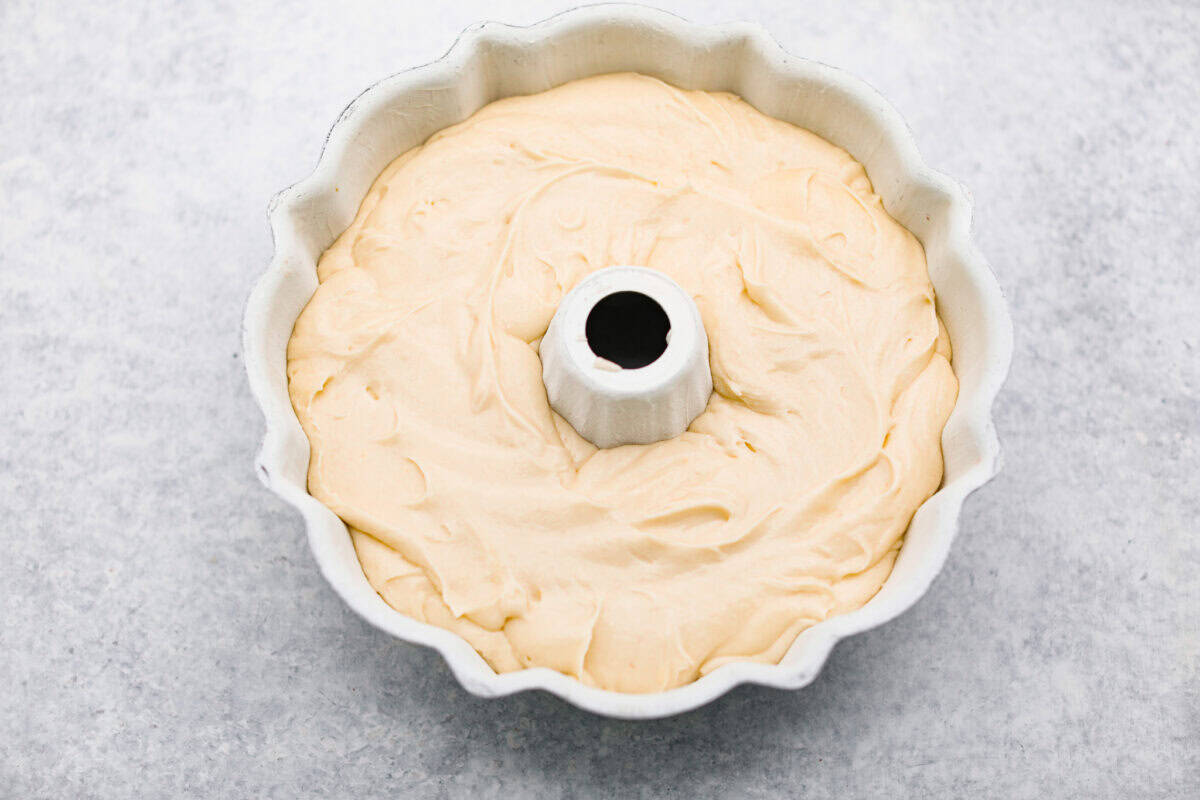 This sour cream pound cake is buttery, moist, and so tender. The light vanilla flavor with a little tang from the sour cream makes it delicious on its own, or even better with berries, whipped cream, or ice cream. Batter added to the prepared bundt pan.