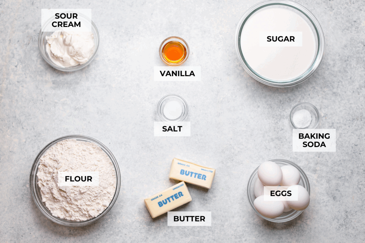 This sour cream pound cake is buttery, moist, and so tender. The light vanilla flavor with a little tang from the sour cream makes it delicious on its own, or even better with berries, whipped cream, or ice cream. Overhead shot of labeled ingredients.