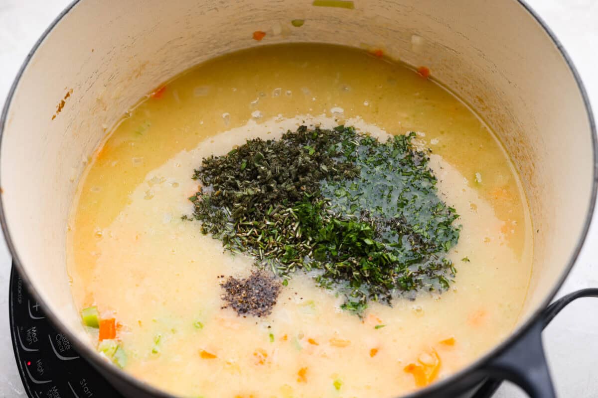 Fresh herbs added to the broth and veggie mixture.
