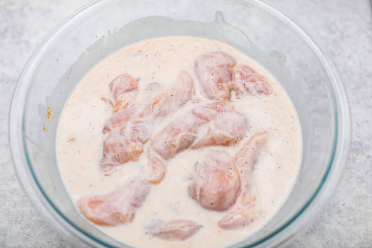 Make this copycat Raising Cane’s chicken tenders at home, no drive-thru required. An easy marinade, simple ingredients, and a quick fry give you crisp, light chicken and that unmistakable Cane’s sauce for a fraction of the cost. Marinade ingredients and chicken all mixed together.